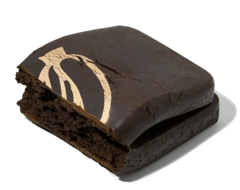 Dark rectangular Banana OG Kush Hash block with a gold banana symbol 3