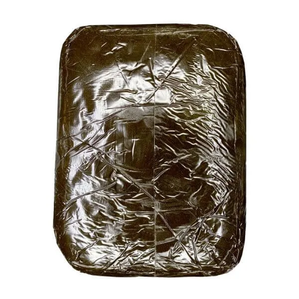 Dark reddish-brown Jamaican Red Gum Hash block with lighter cut interior 2