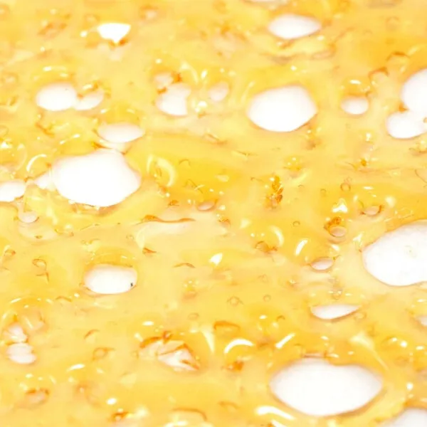 Golden geometric shatter crystal surrounded by cannabis flowers on a green background for OG Kush 2